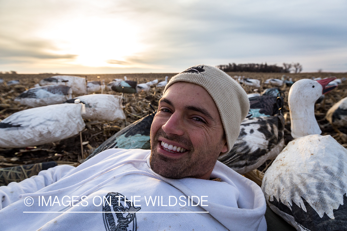 Hunters in field with decoys. 
