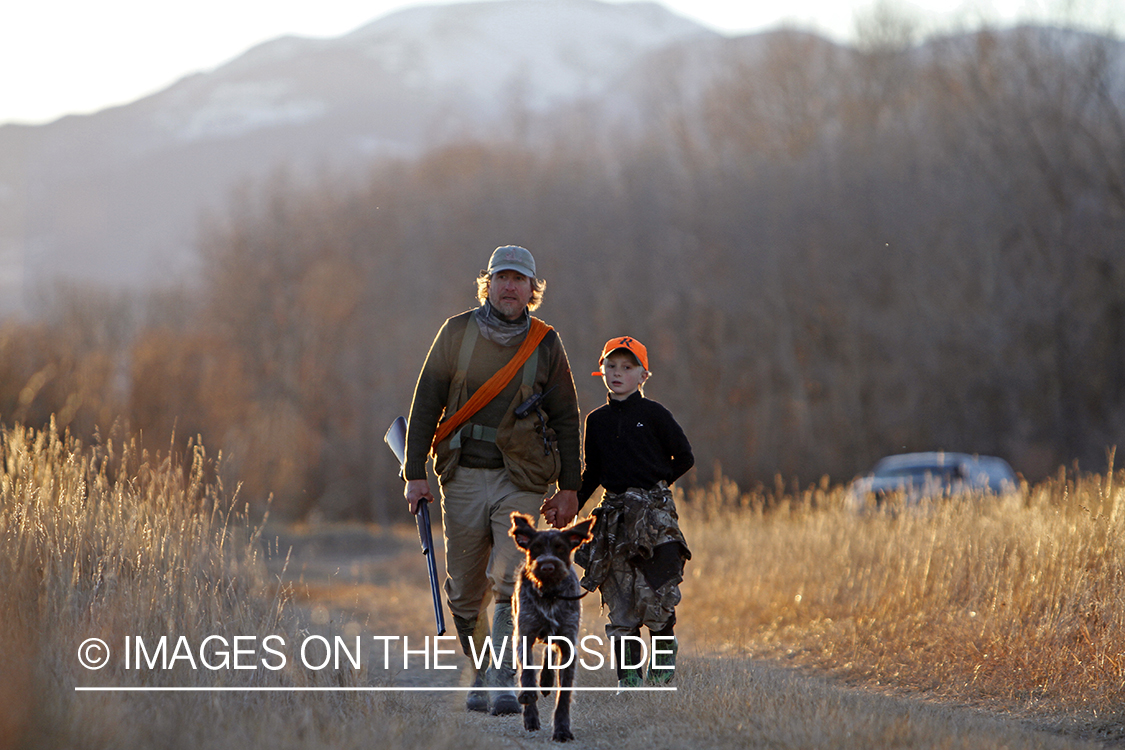 Father and son pheasant hunting.