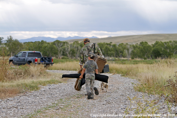 Father and Son walking back to truck after hunting