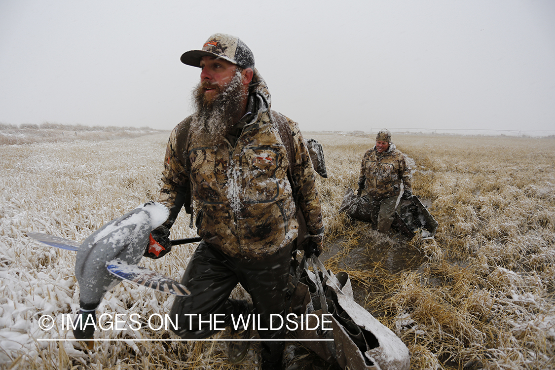 Duck hunters in winter snow condidtions.