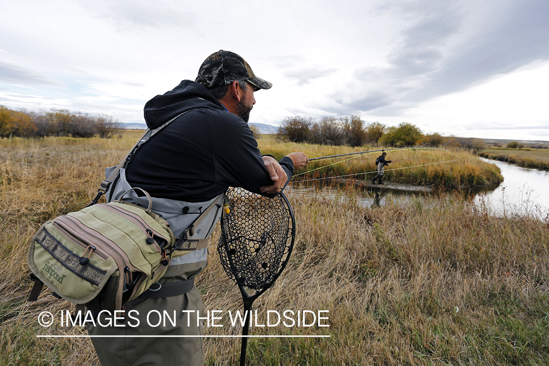 Flyfishermen in field.