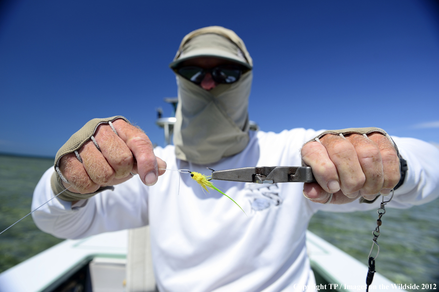 Flyfisherman with fly. 