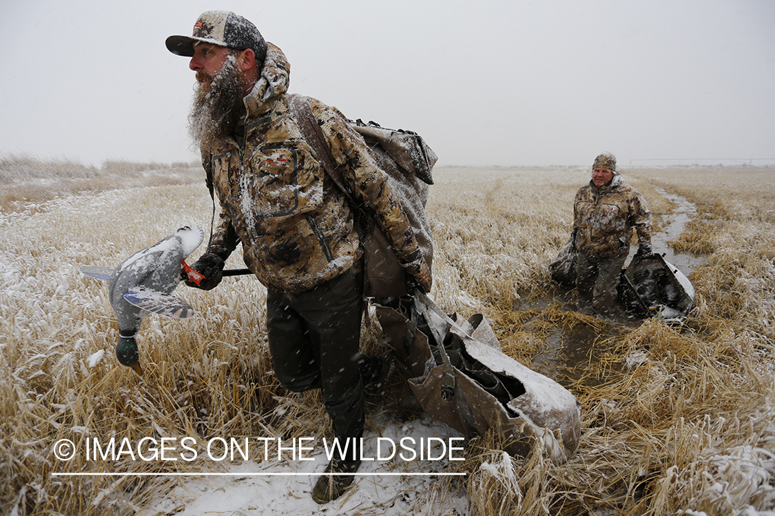 Duck hunters in winter snow condidtions.