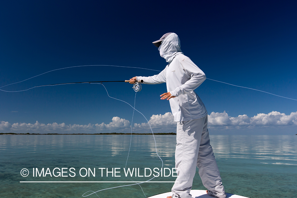 Flyfisherman casting line on flats boat.