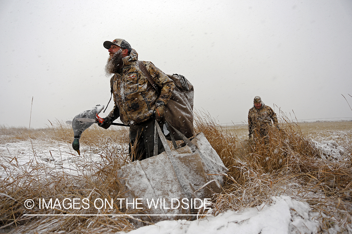 Duck hunters in winter snow condidtions.