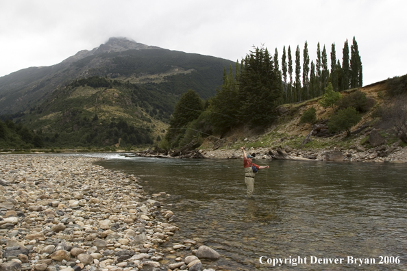 Flyfisherman casting on river.