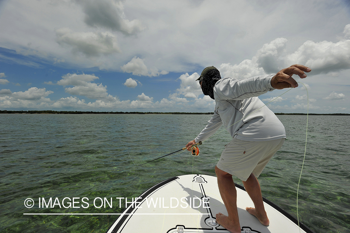 Saltwater flyfisherman casting on flats boat.