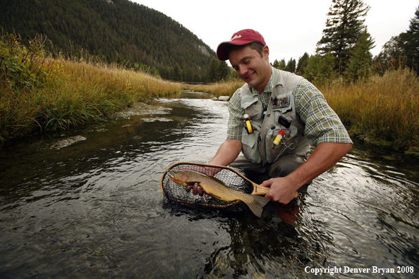 Flyfisherman with Cutthroat Trout in net