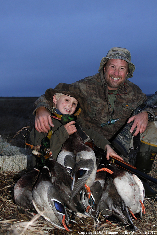 Father and son with bagged waterfowl.