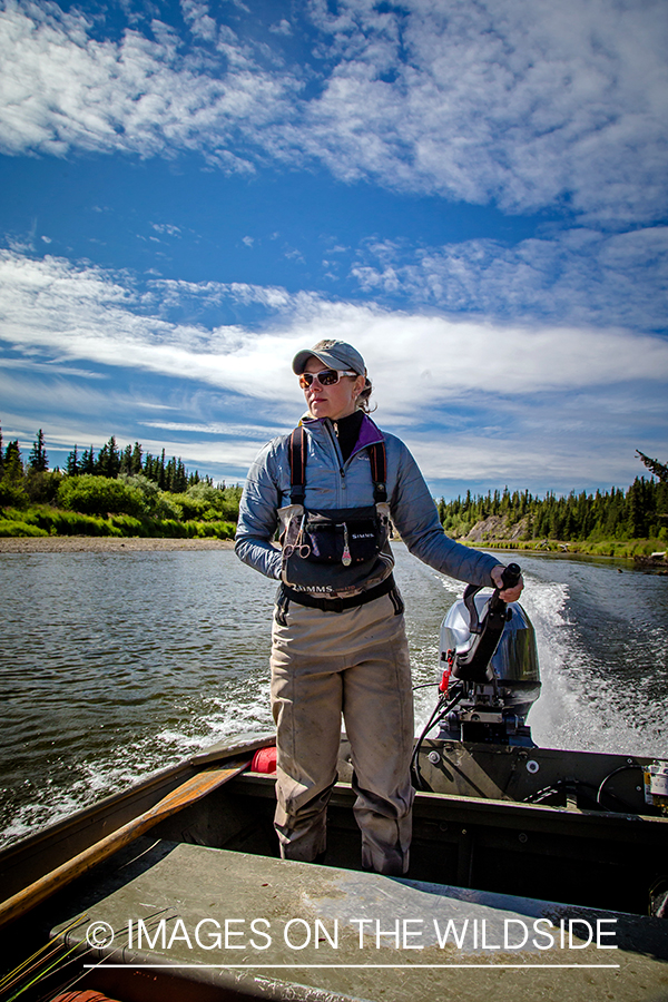 Flyfisherman in fishing boat.