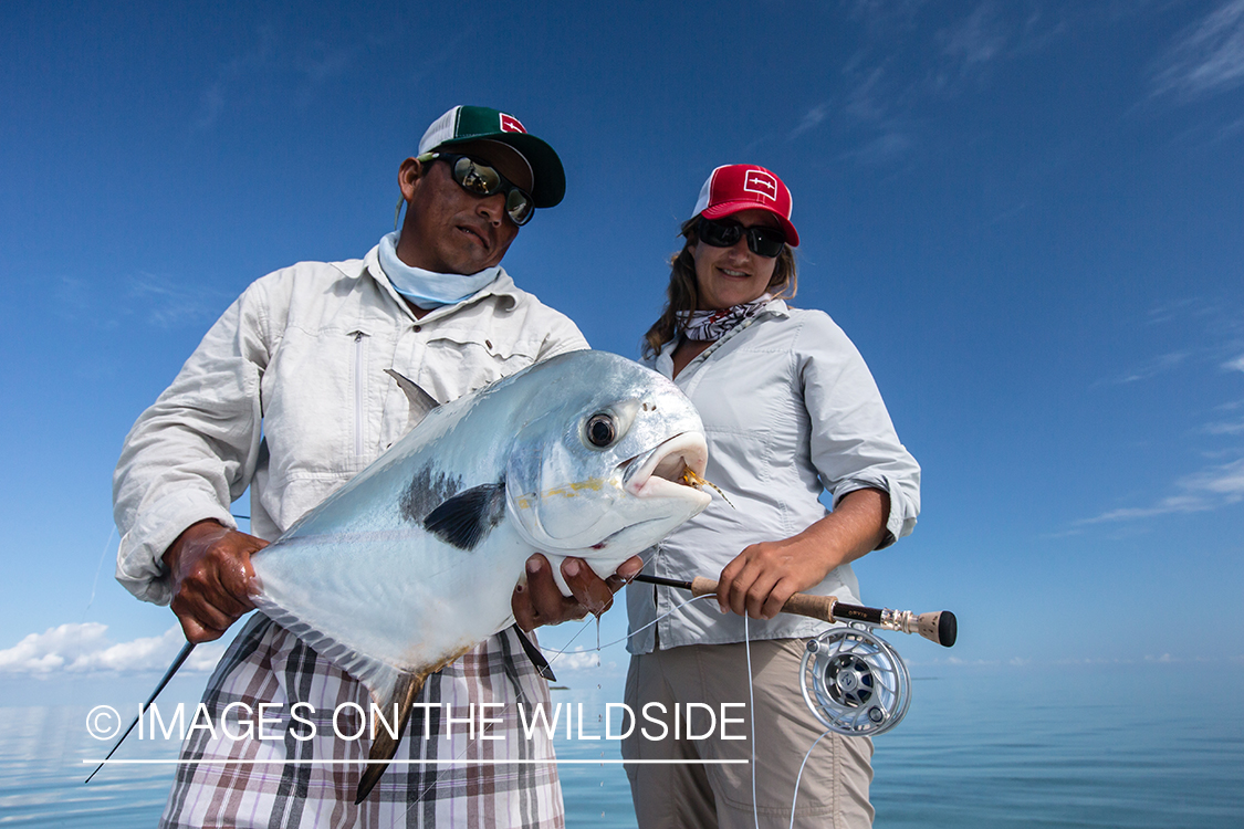 Flyfishing woman and guide with permit.