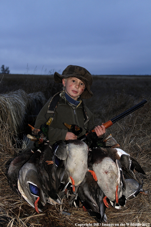 Young hunter with bagged waterfowl.