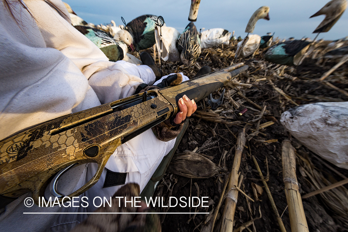 Female goose hunter with shotgun.