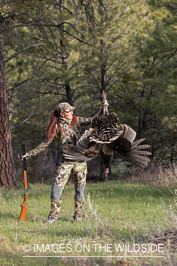 Women hunter with bagged turkey.