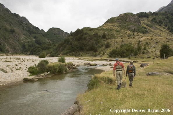 Flyfishermen scanning river for fish.