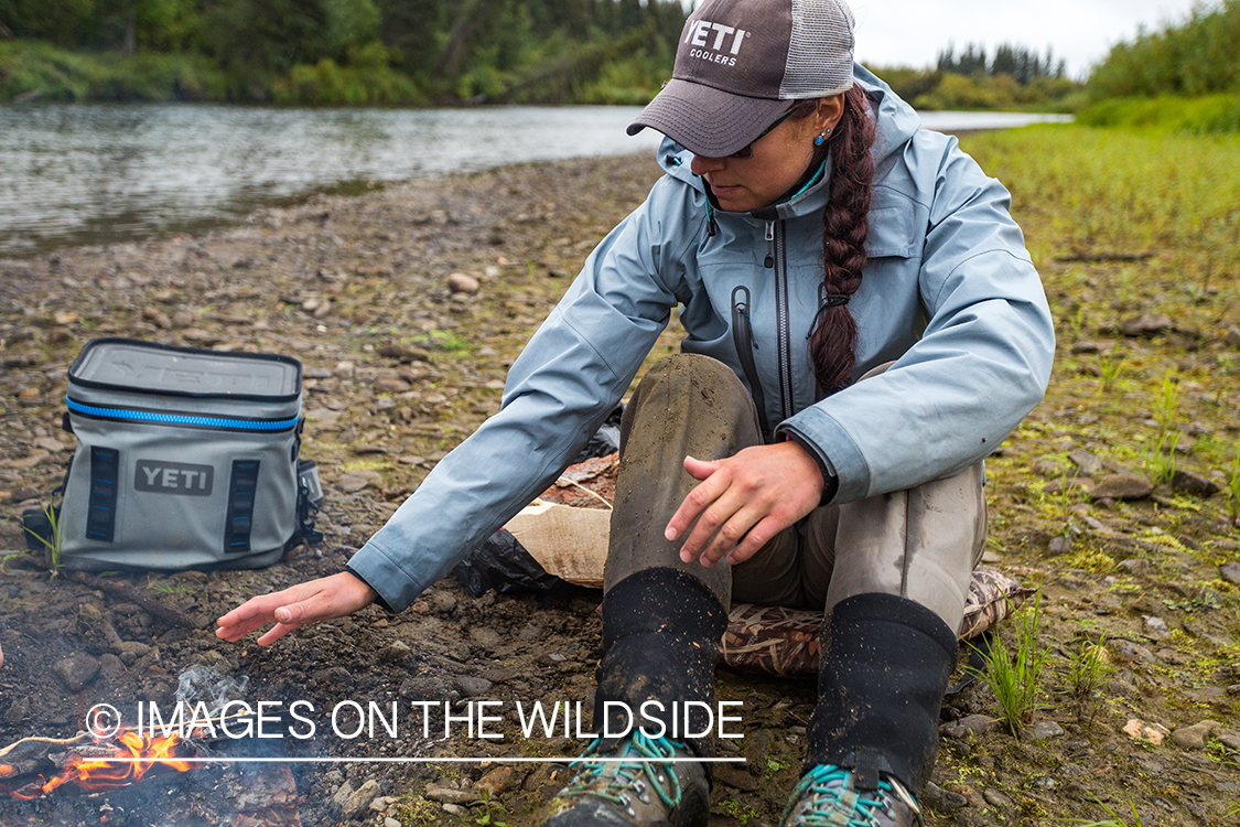 Flyfisher Camille Egdorf next to campfire.