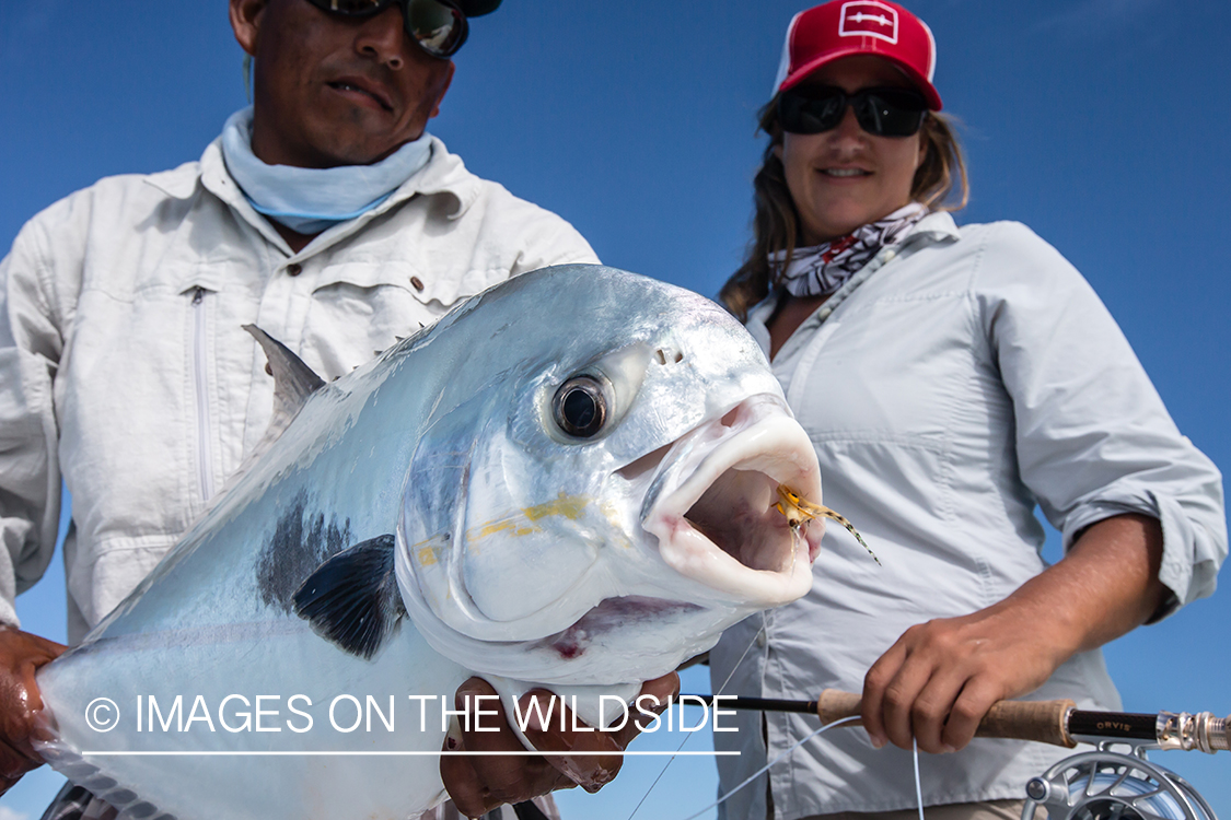 Flyfishing woman and guide with permit.