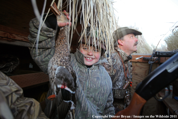 Father and son with bagged mallard. 