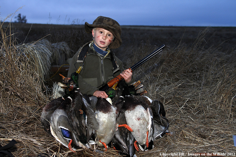 Young hunter with bagged waterfowl.