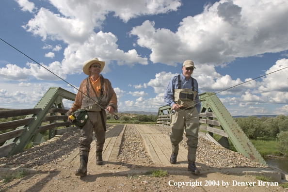 Flyfishermen walking across bridge (MR)