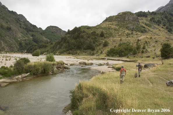 Flyfishermen walking along bank.