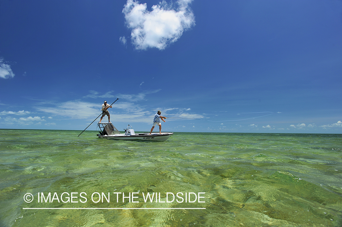 Saltwater flyfisherman casting on flats boat.