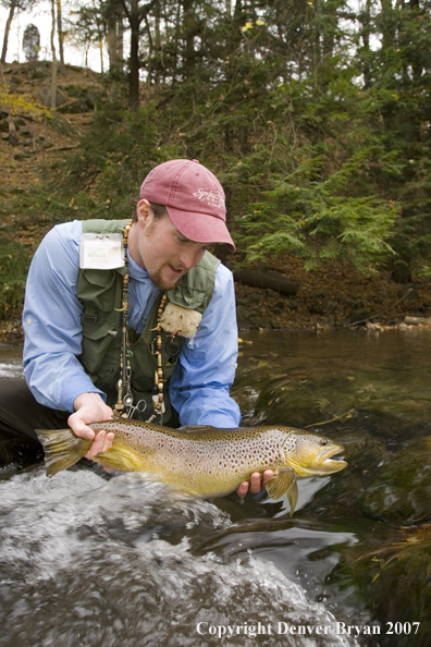 Fisherman holding brown trout