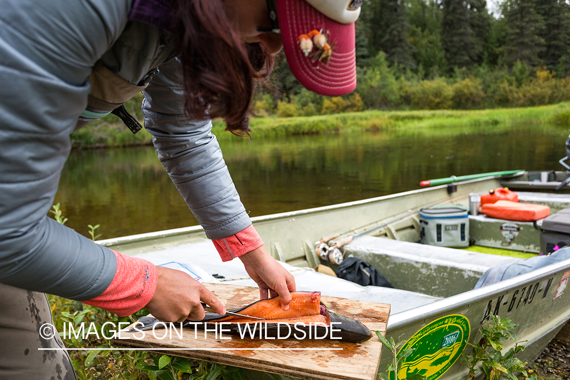 Flyfisher Camille Egdorf filleting salmon. 