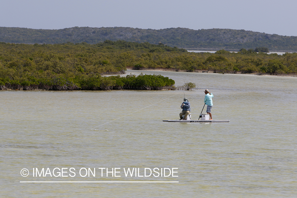 Saltwater flyfisherman fighting fish.