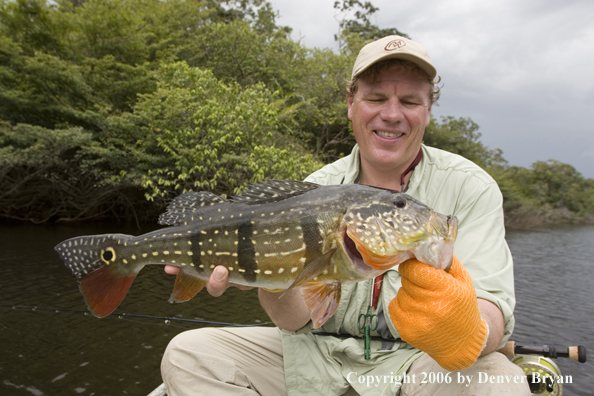 Fisherman holding Peacock Bass