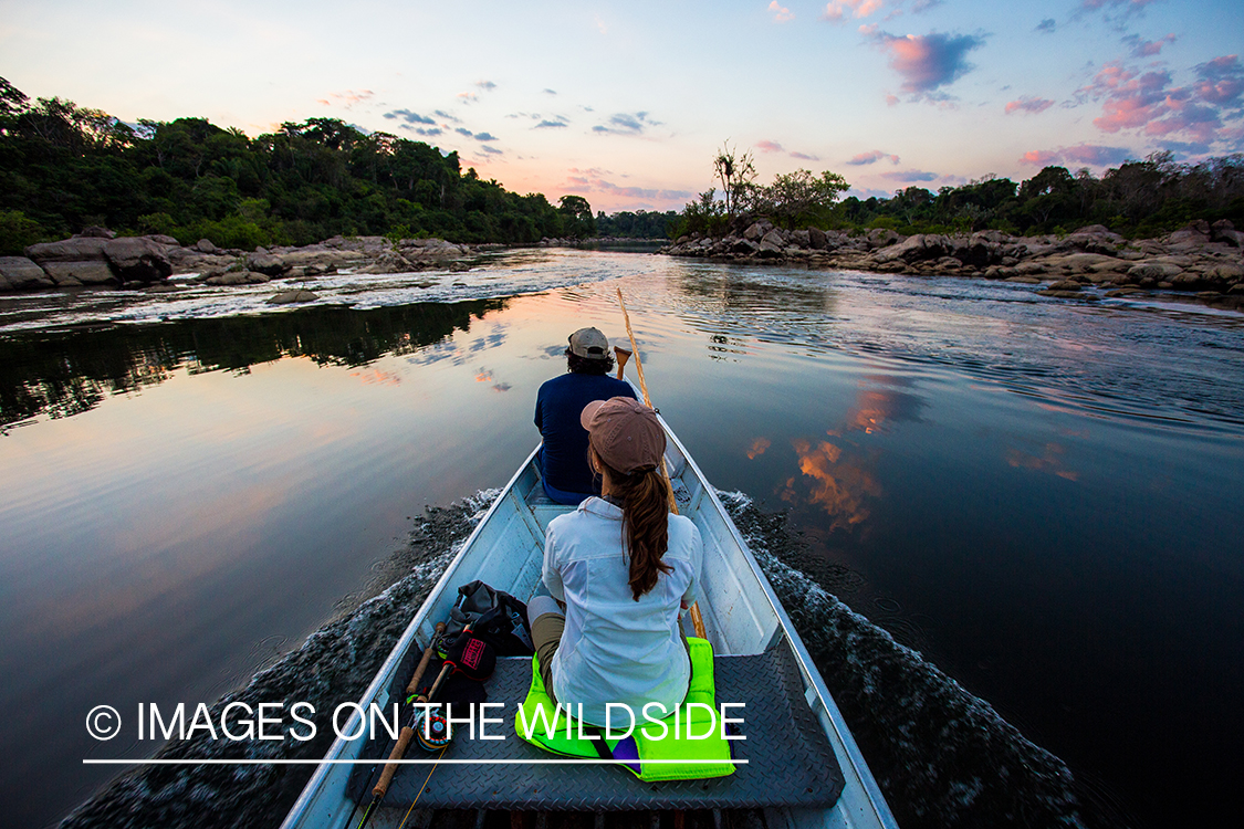 Flyfishermen on boat on river in Kendjam region, Brazil.