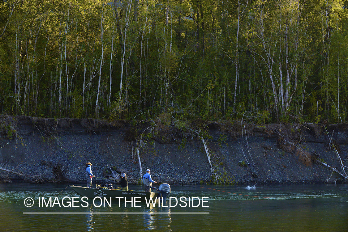 Fishermen on boat in river in Chile.