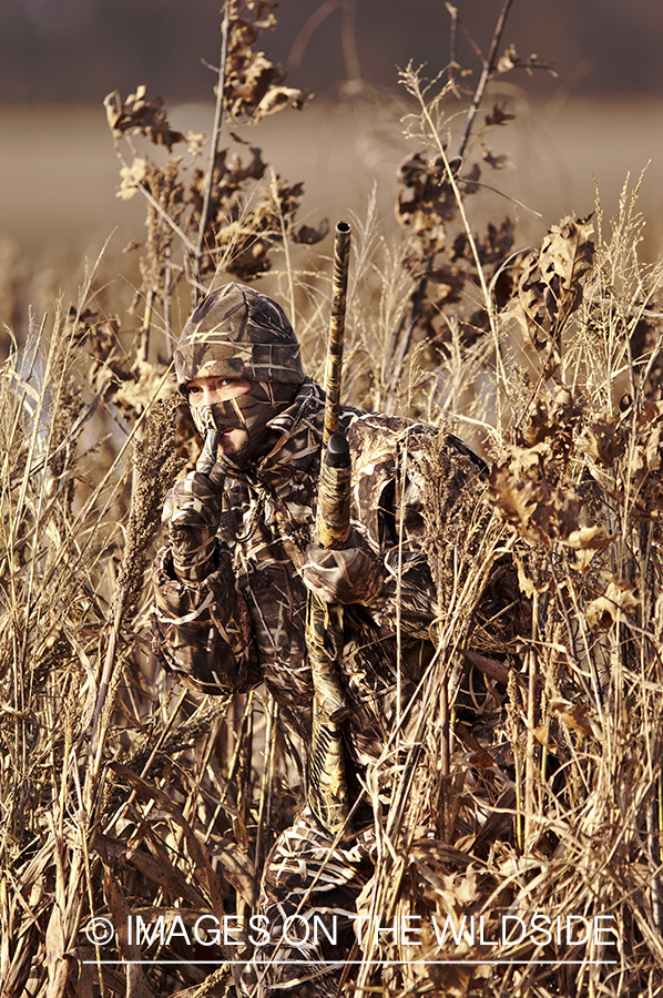 Waterfowl hunter waterfowl calling in wetlands.