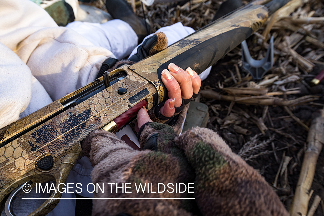 Female goose hunter with shotgun.