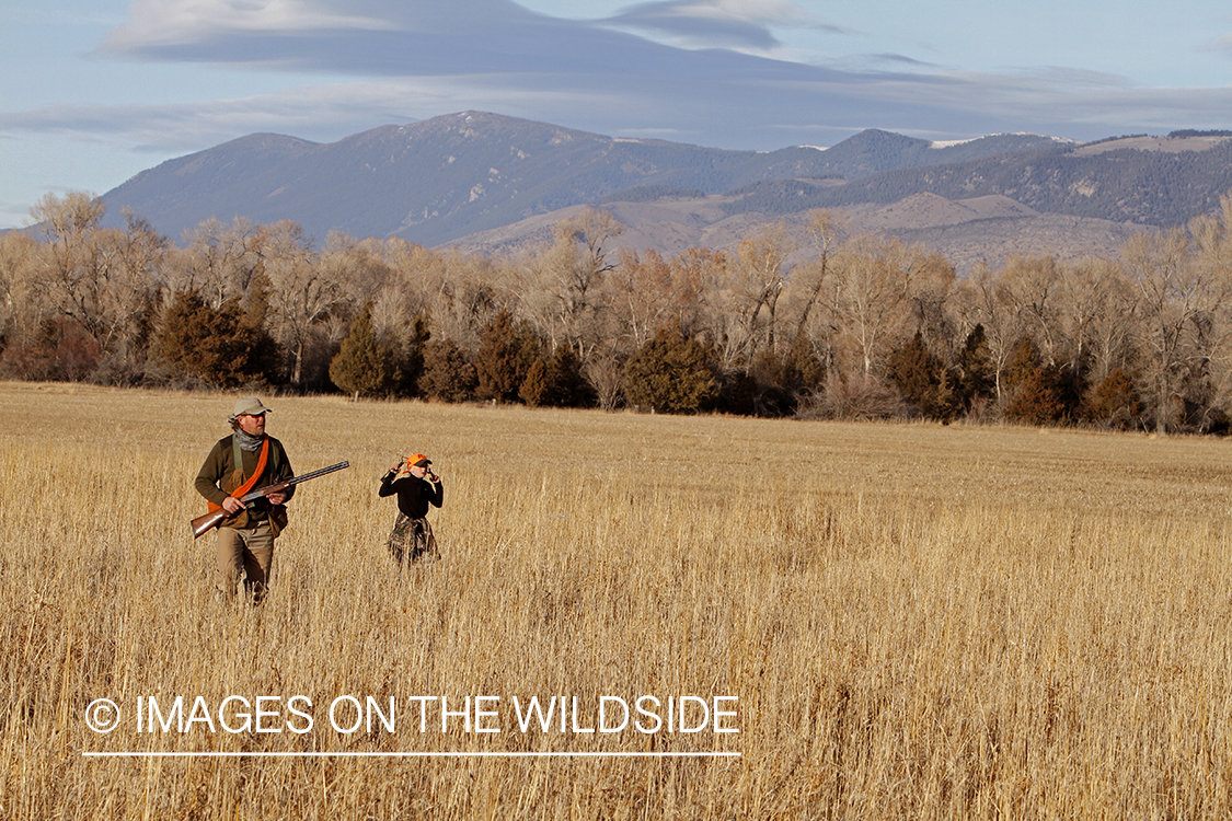 Father and son pheasant hunting.