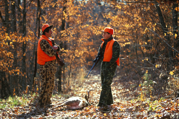 Father and son with white-tailed deer.