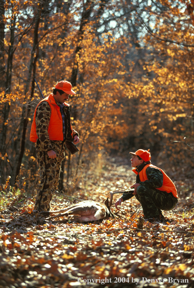 Father and son with white-tailed deer.