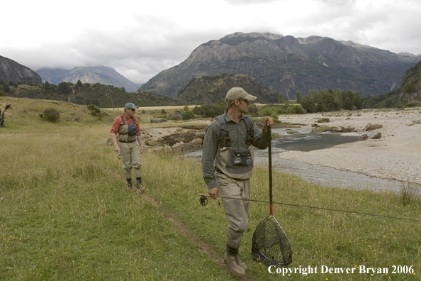 Flyfishermen walking along bank.