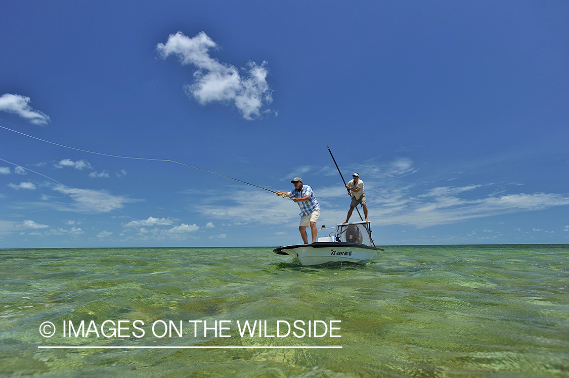 Saltwater flyfisherman casting on flats boat.