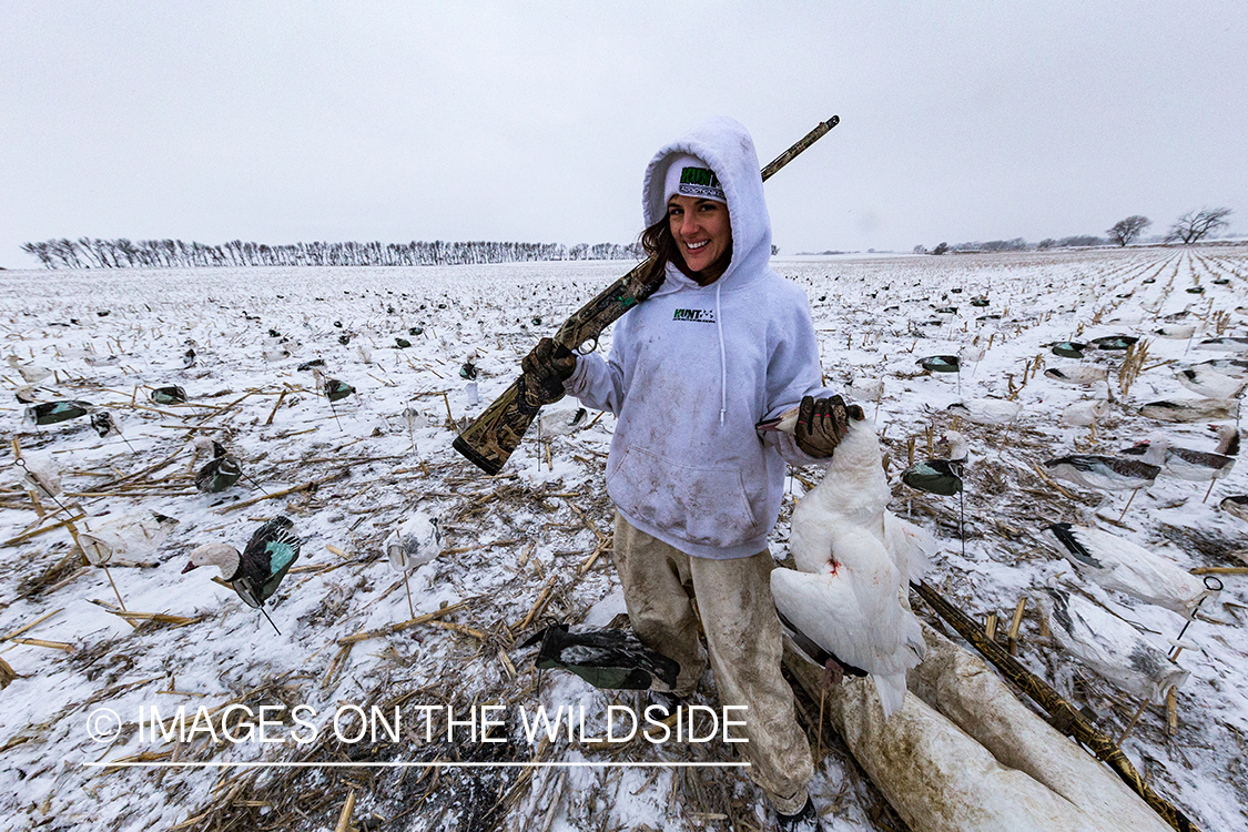 Female goose hunter with bagged goose. 