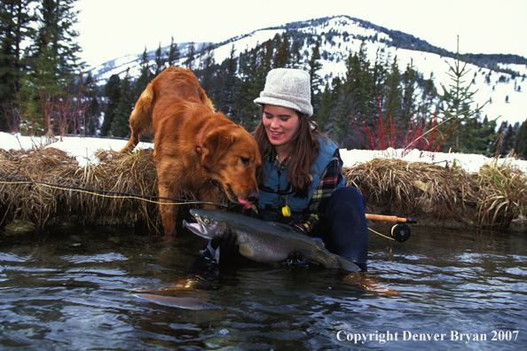 Flyfisher holding large rainbow trout.