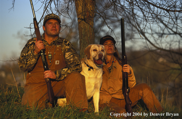 Upland bird hunters with yellow Labrador Retriever.