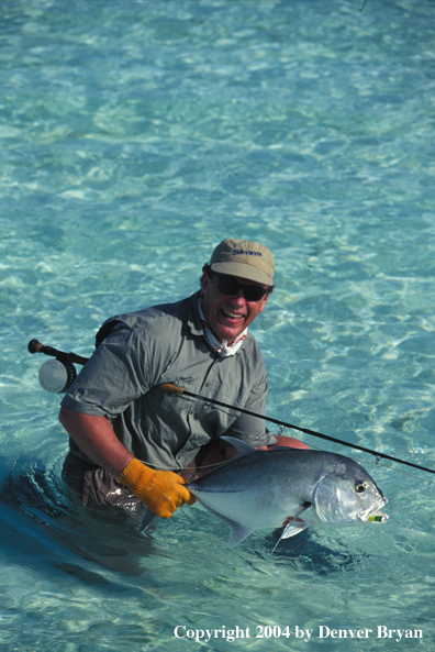 Saltwater flyfisherman holding trevally.