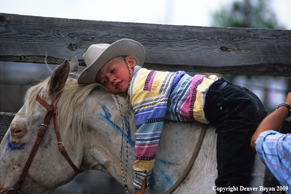 Young cowgirl on horse at county fair