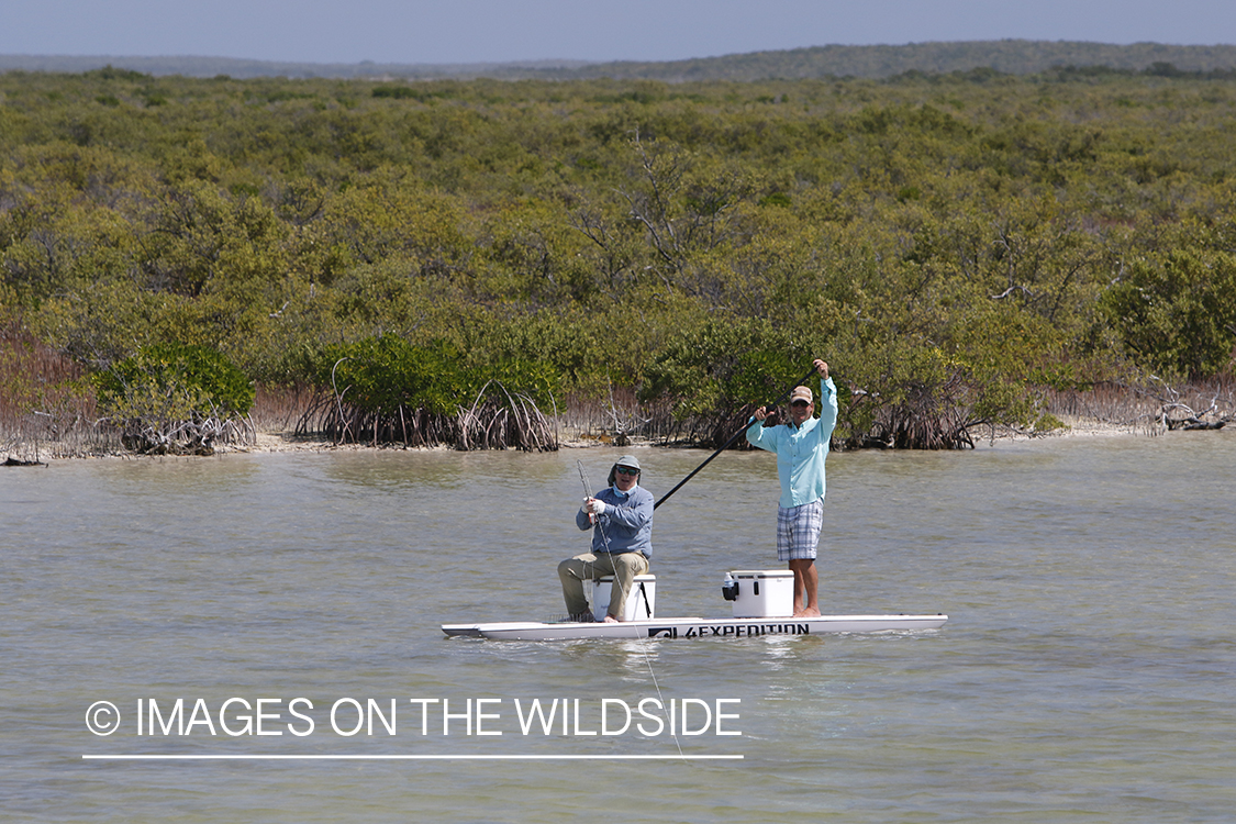 Saltwater flyfisherman fighting fish.