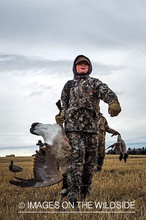 Young hunter with bagged Canada goose.