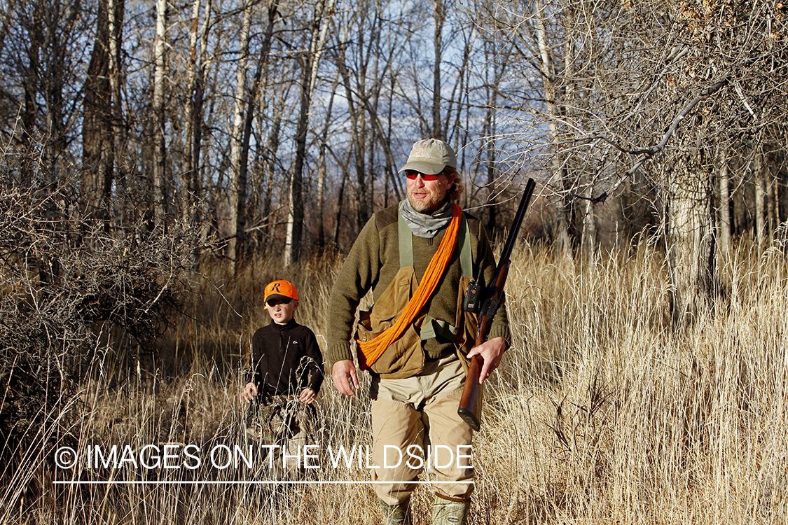 Father and son pheasant hunting.