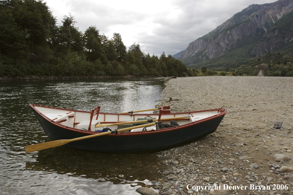 Driftboat beached on riverbank.