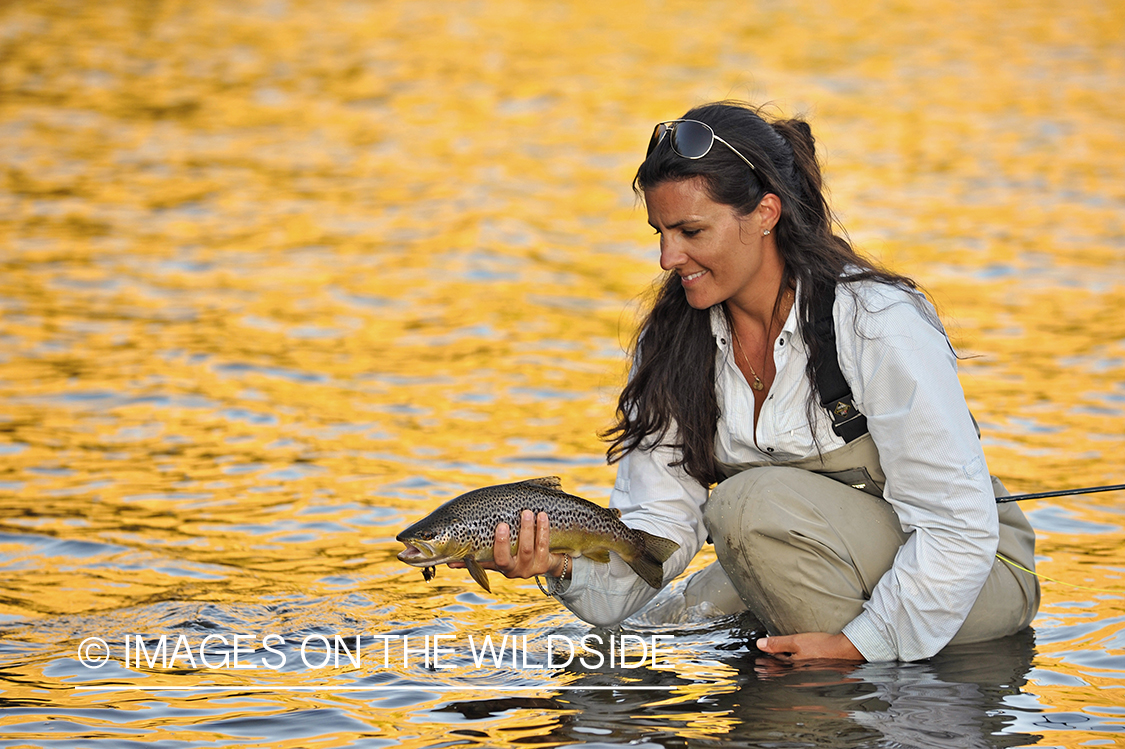 Flyfisherwoman with brown trout.