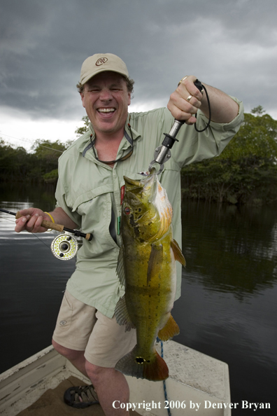 Fisherman holding Peacock Bass